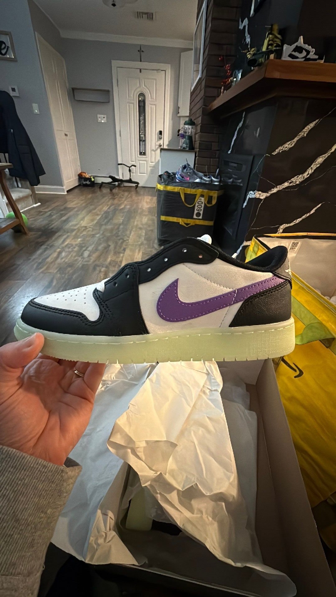0343 Nike Air Jordan 1 Retro Low OG 'Black Raspberry' sneaker featuring black and white leather with a glow-in-the-dark "Volt Tint" outsole