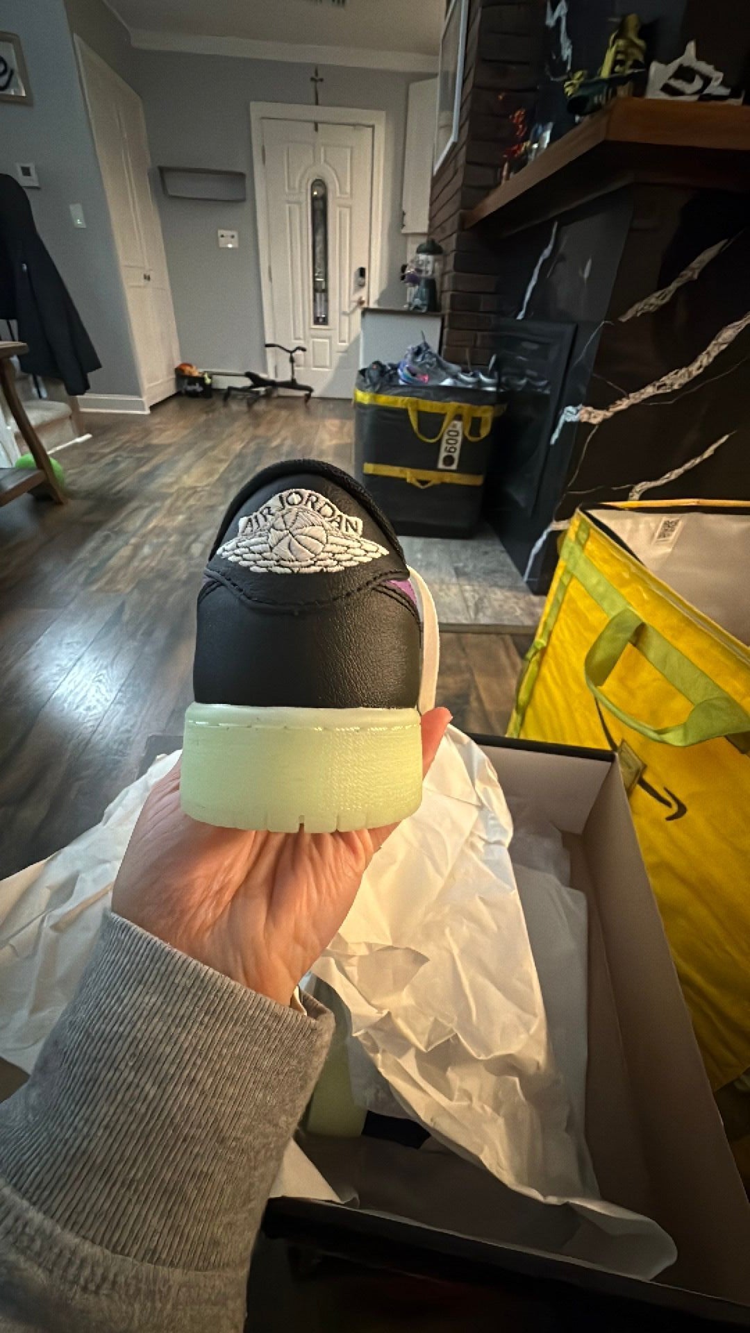0343 Nike Air Jordan 1 Retro Low OG 'Black Raspberry' sneaker featuring black and white leather with a glow-in-the-dark "Volt Tint" outsole