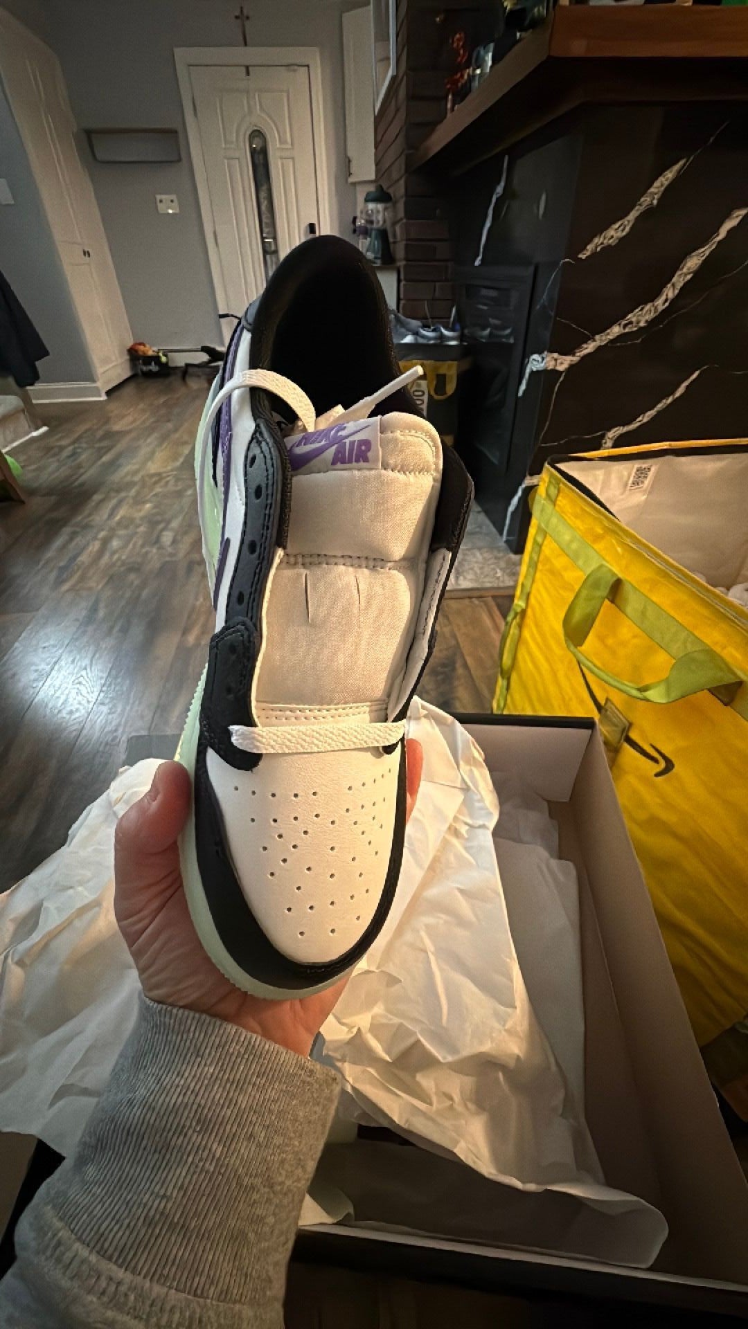 0343 Nike Air Jordan 1 Retro Low OG 'Black Raspberry' sneaker featuring black and white leather with a glow-in-the-dark "Volt Tint" outsole