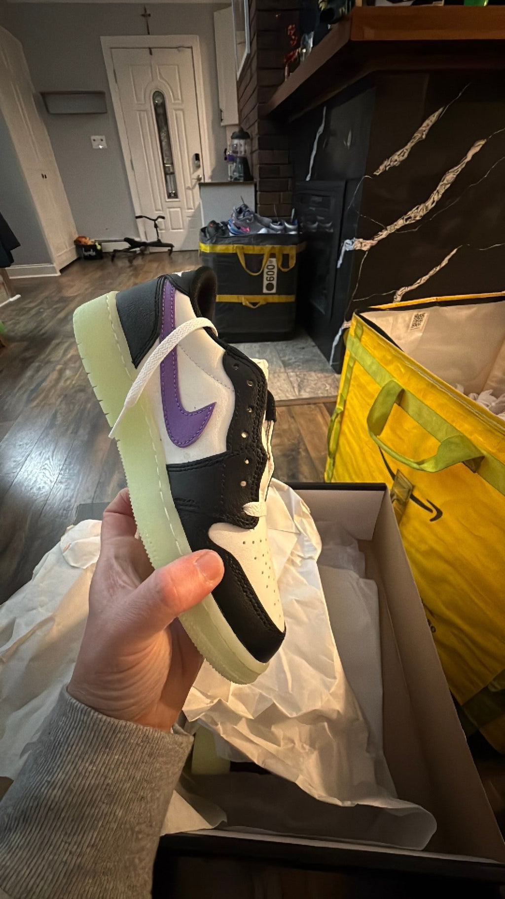 0343 Nike Air Jordan 1 Retro Low OG 'Black Raspberry' sneaker featuring black and white leather with a glow-in-the-dark "Volt Tint" outsole